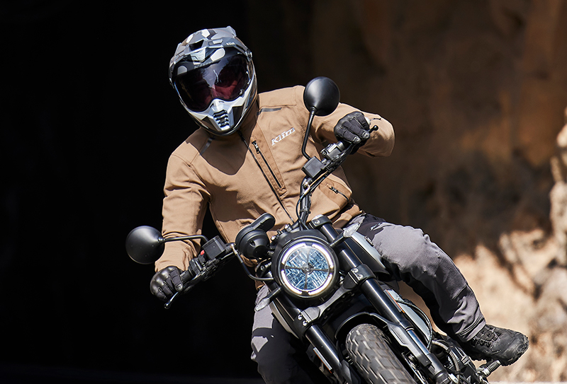 Guy riding out of tunnel wearing Klim Marrakesh jacket
